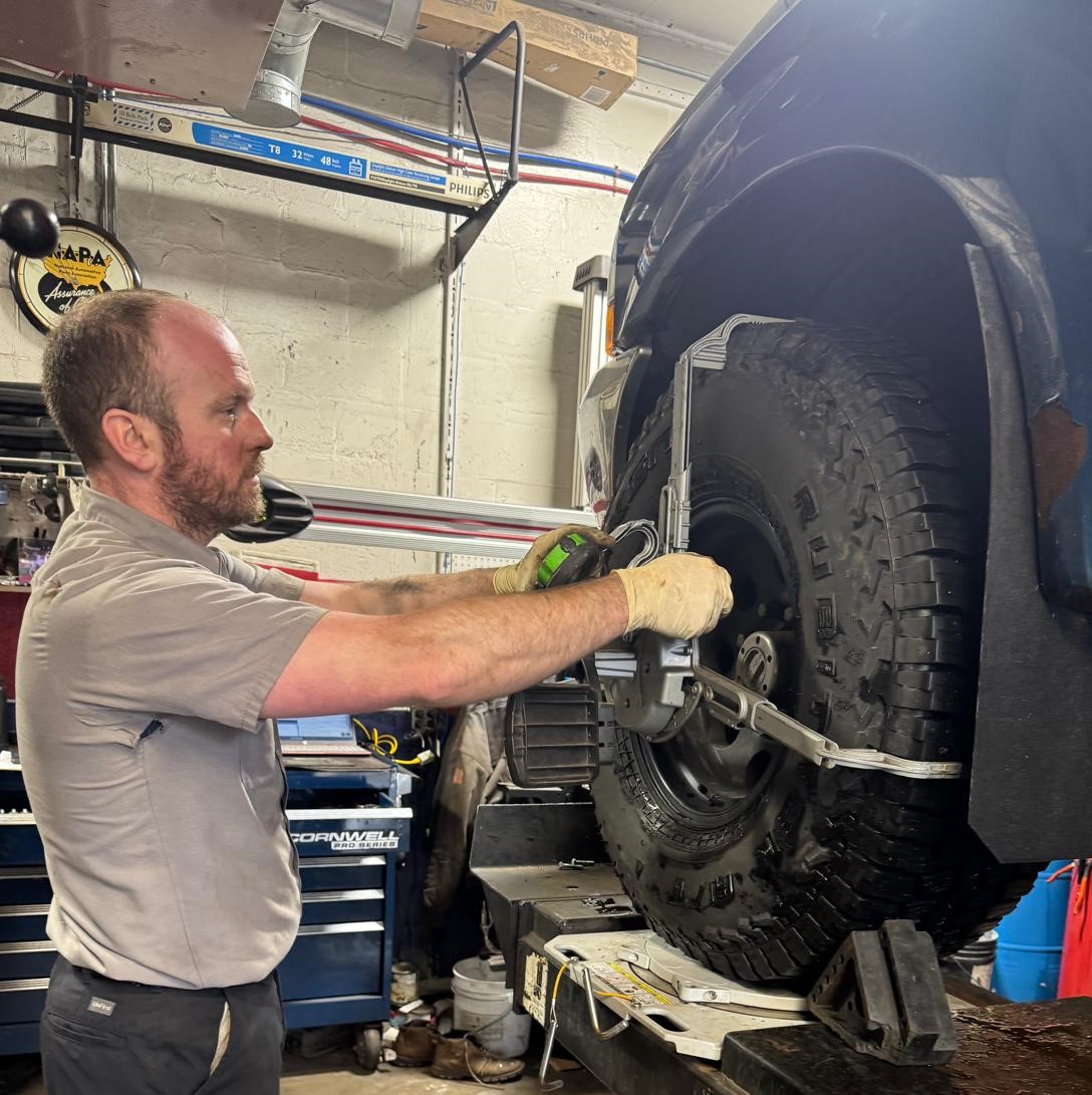 Jeep Wrangler on lift in garage